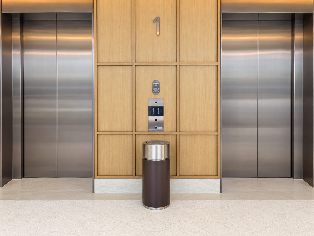 Brushed steel and leatherette lobby bin produced by Milano Group